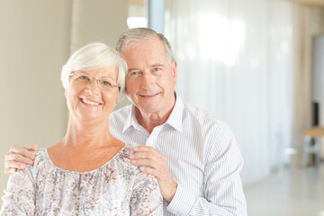 Older couple smiling together indoors