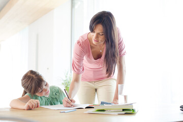 Mother helping daughter with homework