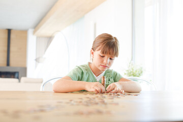 Girl stacking pennies on counter