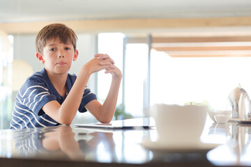 Boy posing at kitchen counter