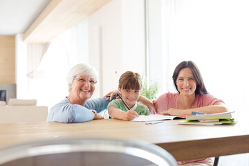 Fototapeta premium Mother and grandmother helping girl with homework