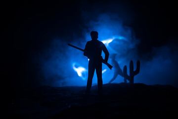 Western cowboy silhouette with texture at sunset and slivers of light