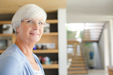 Older woman in living room, smiling