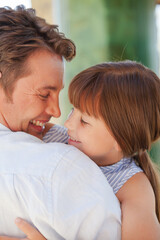 Father and daughter hugging outdoors