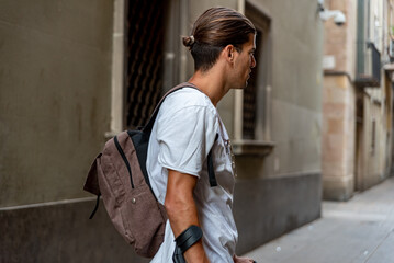 Young latin man with crutches visiting the city