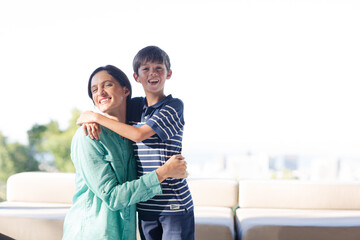 Mother and son hugging outdoors