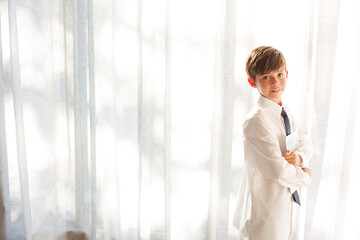 Boy in shirt and tie holding tablet computer