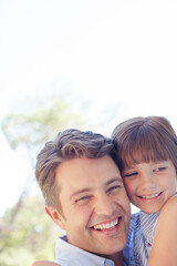 Father and daughter hugging outdoors