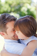 Father and daughter hugging outdoors