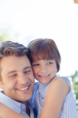 Father and daughter hugging outdoors