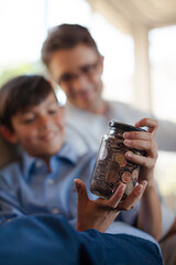 Father and son holding change jar