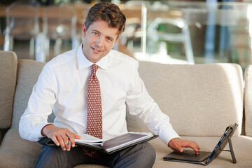 Businessman smiling on sofa