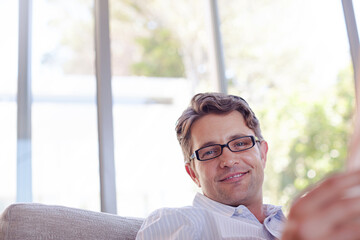 Businessman smiling on sofa