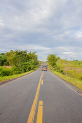 red car on the road in a colombian countryside