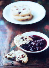 Cranberry cookies with jam on rustic wooden background. Close up.