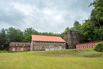 Obraz premium Arden, NY - USA - Aug. 28, 2021: Landscape view of the crumbling remains the Clove Furnace Ruin, a longtime smelting site for iron ore mined from nearby veins in the Ramapo Valley.