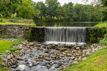 Monroe, NY - USA - Aug. 28, 2021: Horizontal view of the historic Dam and mill pond from Smith's...