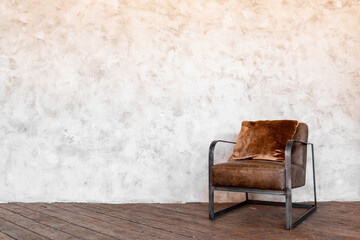 A brown chair against a white wall. Minimalist hall with a chair