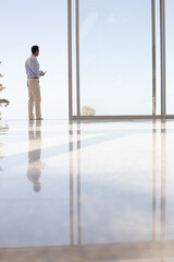 Businessman standing at office window