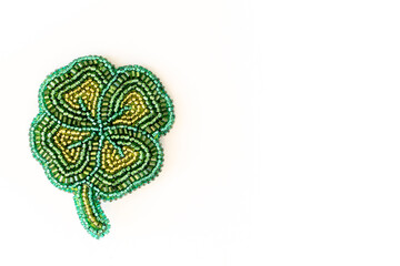 beaded clover with four leaves on a white background. beaded brooch. accessory for ladies. top...