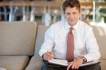 Businessman smiling on sofa