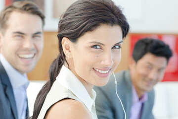 Businesswoman listening to headphones in office