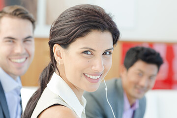 Fototapeta premium Businesswoman listening to headphones in office
