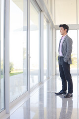 Businessman standing at office window