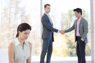 Businessmen shaking hands in office
