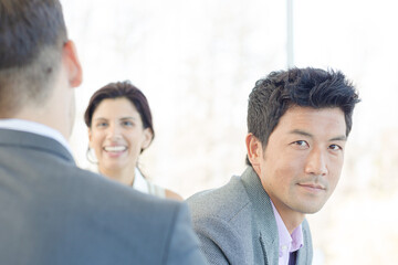 Businessmen smiling in office