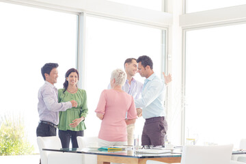Business people cheering in office