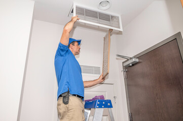 Technician checking an air filter