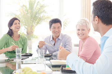 Business people smiling in lunch meeting