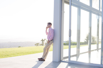 Businessman using cell phone outside office