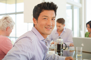 Businessmen smiling in office