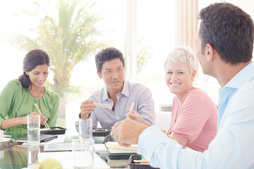 Business people smiling in lunch meeting
