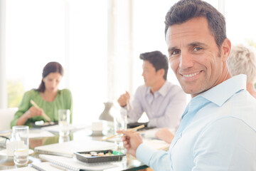 Businessman smiling in lunch meeting