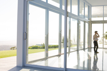 Businessman standing at office window