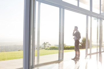 Businessman talking on cell phone outdoors