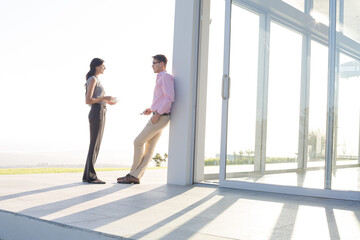 Business people talking outside office