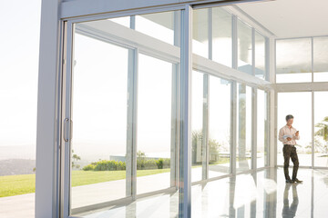 Businessman standing at office window