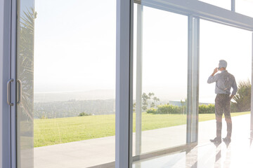 Businessman talking on cell phone outdoors