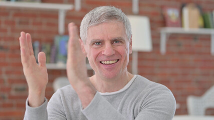 Portrait of Cheerful Old Man Clapping
