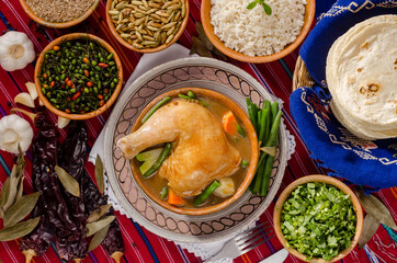 Pepián, a traditional dish of Guatemala gastronomy, with spice sauce, and vegetables.