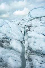 beautiful curves in white ice made by melted water in glacier