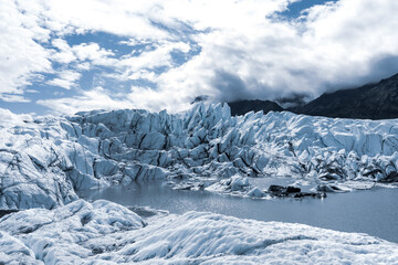 beautiful view on melting glacier blue ice with mountains around