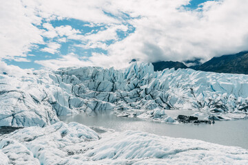 beautiful view on melting glacier blue ice with mountains around