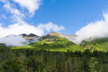 beautiful view of mountain with waterfall and white cloud on foreground