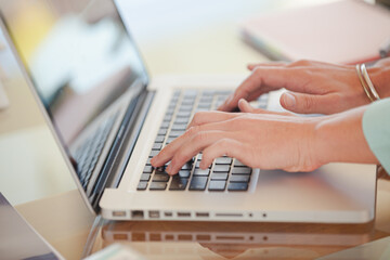 Fototapeta na wymiar Businesswoman using laptop at desk