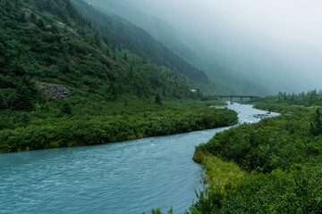 foggy mountain landscape with a bridge and beautiful river